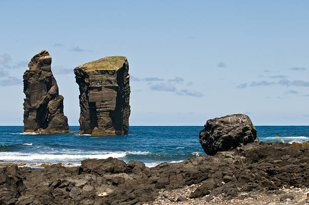 Massive lava stone pillars in the sea