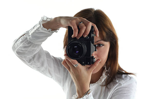 istock young woman with old camera isolated on white background 147660312