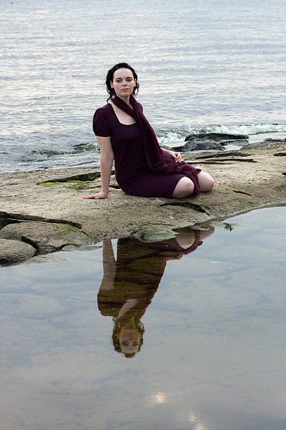 Young woman by water stock photo