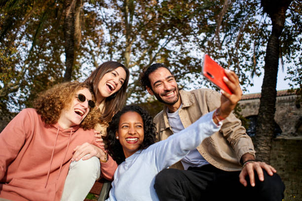 istock Group of multi-ethnic young smiling people taking selfie. 1476611730