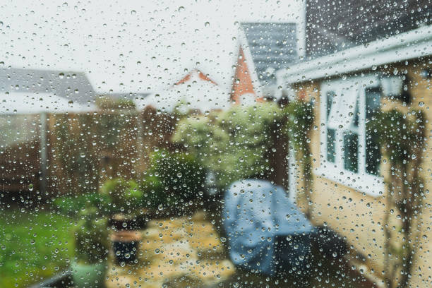 Shallow focus of raindrops seen on a conservatory window. stock photo