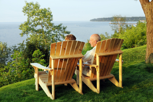 A senior couple enjoying a high lakeside view.