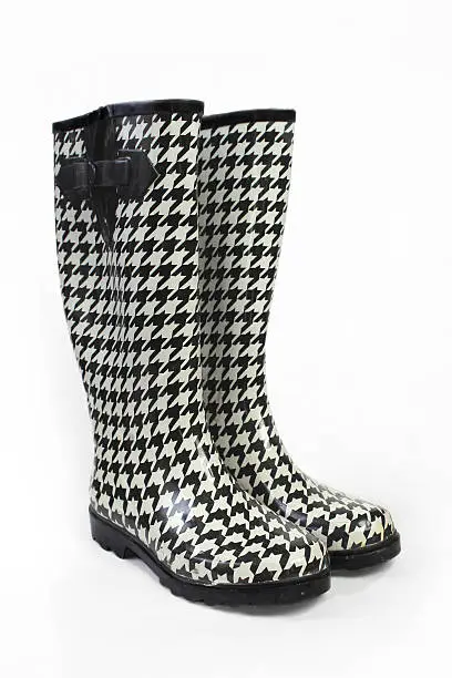 Black and white patterned rainboots on white.