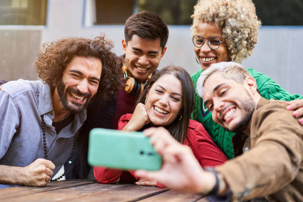 istock Happy multiracial friends having fun taking selfie - Young happy people together using smartphone 1476618504
