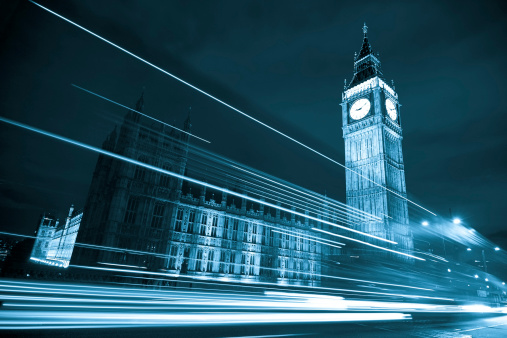 Nocturne scene with Big Ben behind light beams, blue toned.