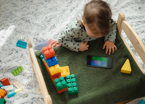 istock Young child playing with mobile phone 1476621293