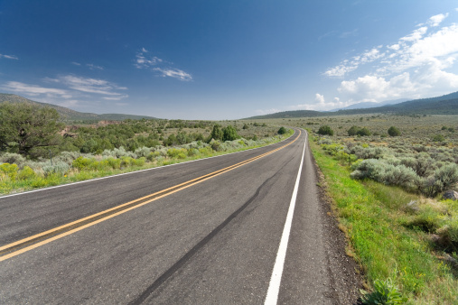 Wide angle shot of a highway outside Taos, New Mexico.  Skid mark in the foreground. - See lightbox for more