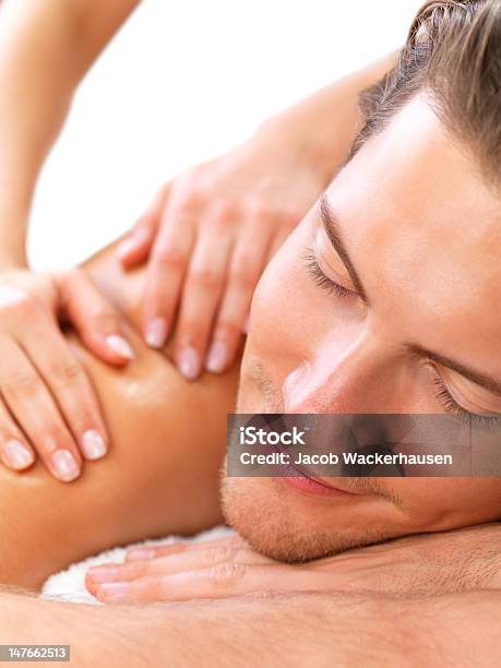 Closeup Of Young Man Receiving Shoulder Massage At Day Spa Stock Photo - Download Image Now