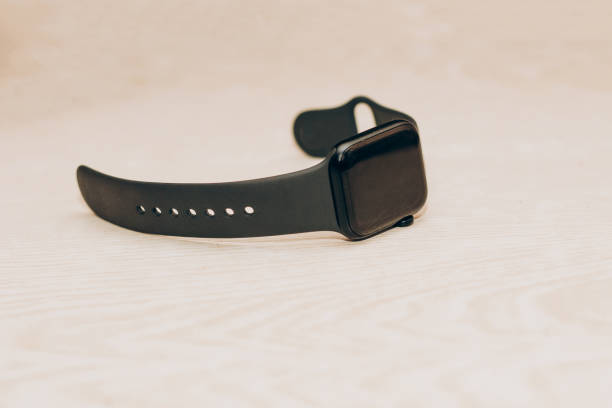 istock A black technological smart watch lies on a wooden background 1476626809