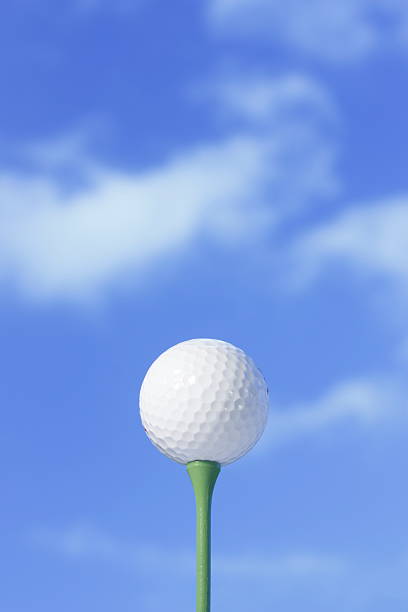 istock Golf ball against blue sky on a green tee. 147663085