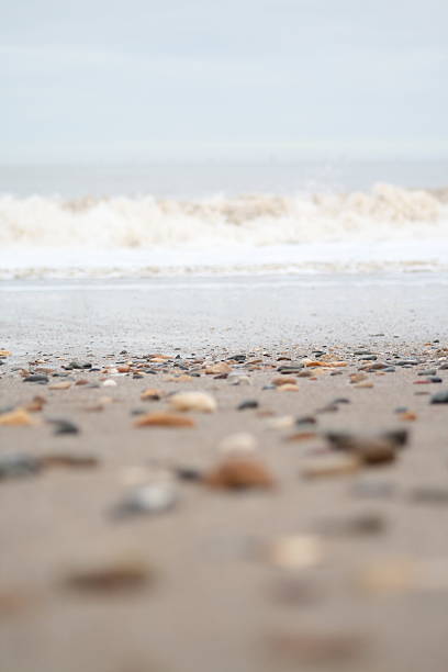 Pebbles and breaking waves stock photo