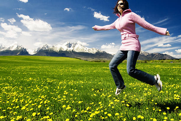 istock Young girl jumping on a meadow 147663276