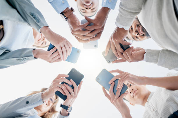 istock Phone in hands, technology and business people, collaboration and communication in team for company. Chat, internet and community diversity, networking and typing in teamwork circle from below 1476635631