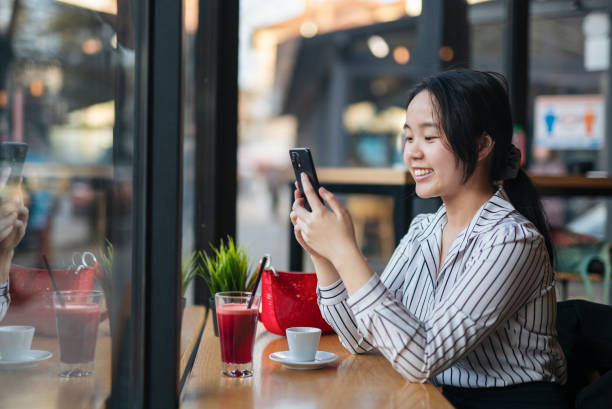 istock Woman on cafe using phone for online banking. 1476650717