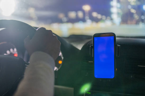 istock Male driver using GPS on smartphone at night 1476651930