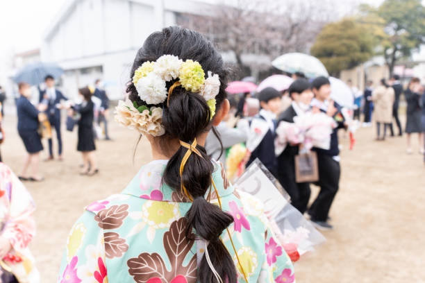 elementary school girl attending an elementary school graduation ceremony wearing a hakama
