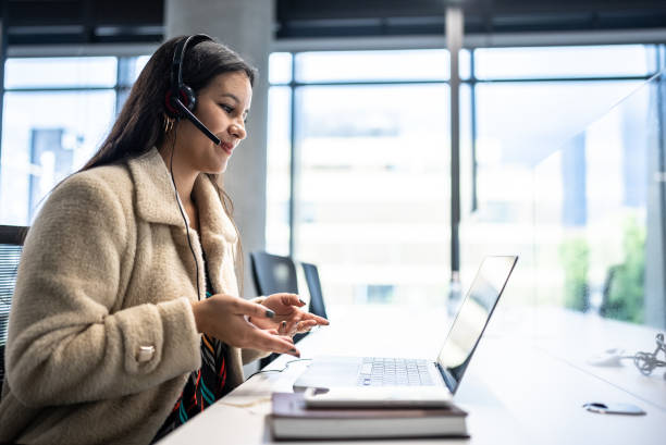istock Young woman working on a call center in the office 1476654479