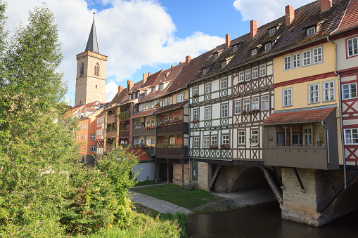 Medieval arch bridge Krämerbrücke crossing river Gera with half-timbered shops and houses in the city of Erfurt, Germany