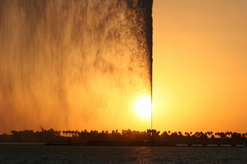 Colorful jet of water at sunset. Jeddah. Saudi Arabia