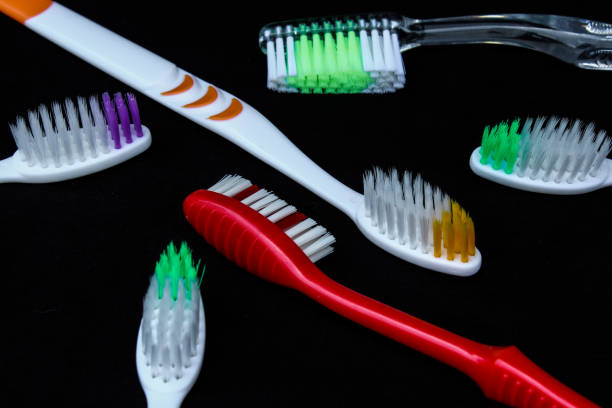 istock Close up Colorful toothbrushes isolated on black background 1476658530