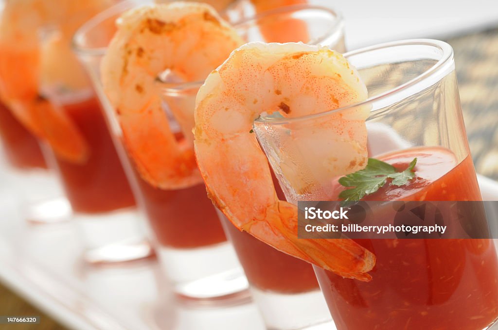 An up close picture of a seafood appetizer Shrimp cocktail in shot glass shot closeup. Shrimp Cocktail Stock Photo