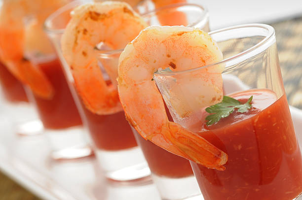 An up close picture of a seafood appetizer Shrimp cocktail in shot glass shot closeup. shrimp cocktail stock pictures, royalty-free photos & images