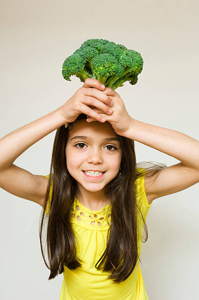 istock Young Girl Holding Broccoli 147666433