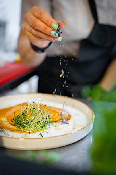 istock Chef cooking Roasted salmon steak with pumpkin cream on restaurant kitchen 1476664790