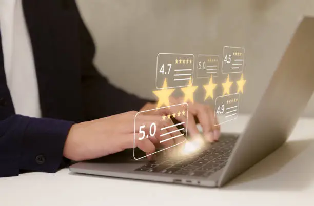 Photo of User give five star rating to service experience on computer app. Customers opinion evaluate the quality of services to reputation and business success. Customer review satisfaction survey concept.