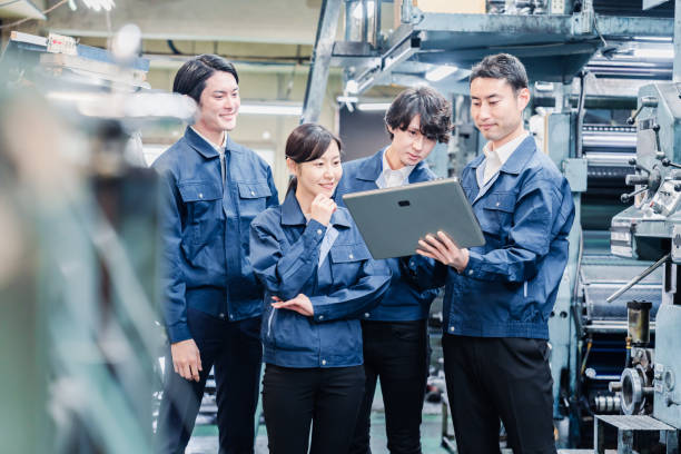 istock Factory staff meeting while looking at a tablet terminal 1476668251