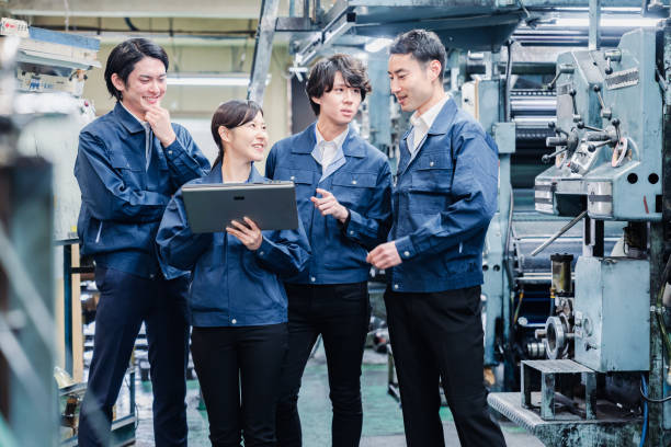 istock Factory staff meeting while looking at a tablet terminal 1476668253