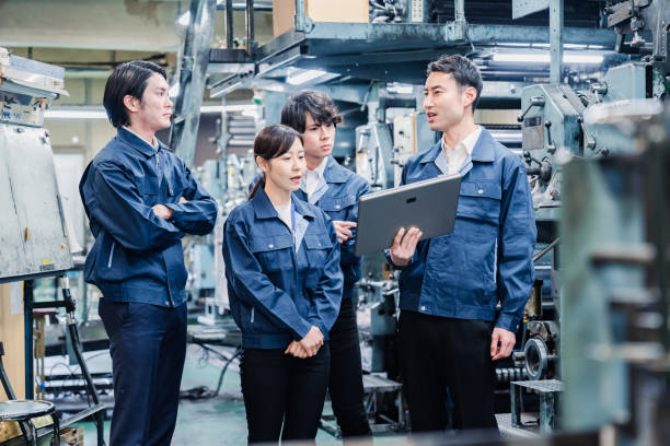 istock Factory staff meeting while looking at a tablet terminal 1476668280