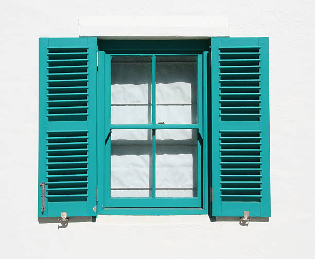 istock Opened turquoise wooden window on a white house 147666962