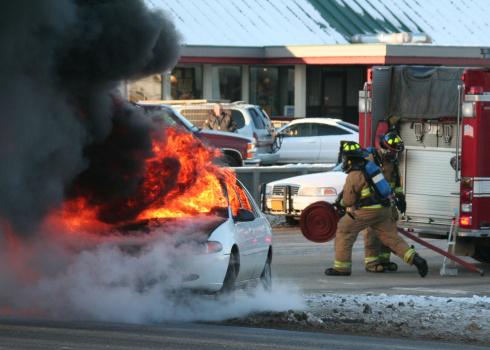 A car catches fire after colliding with another car. Firemen to the rescue!
