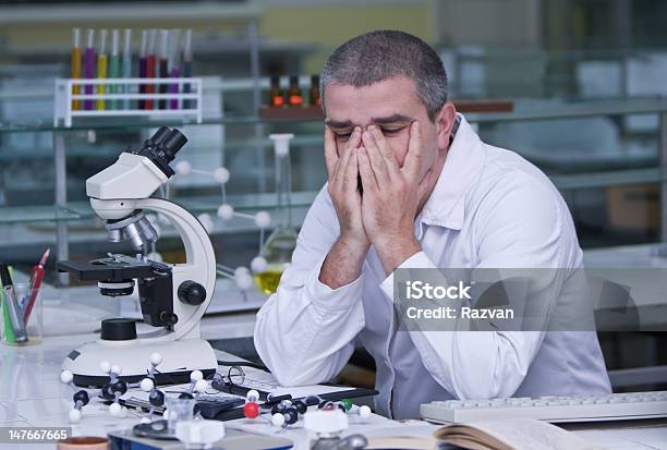 A Tired Researcher At His Workplace Stock Photo - Download Image Now - Adult, Adult Student, Adults Only