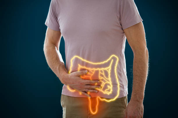 The man holding his stomach in pain stock photo