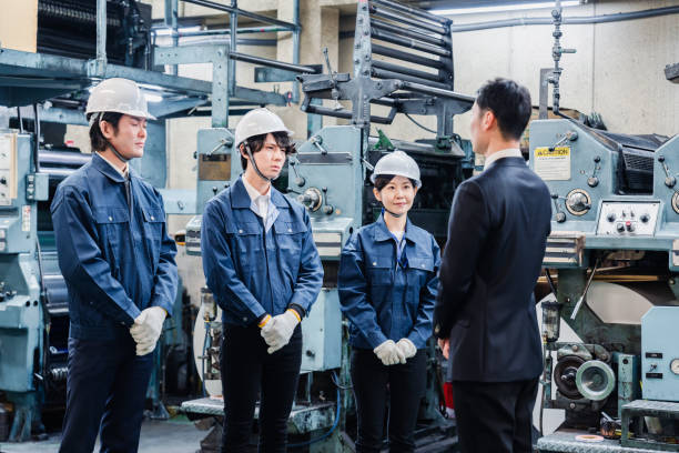 istock Factory staff listening to a manager's instruction 1476683384