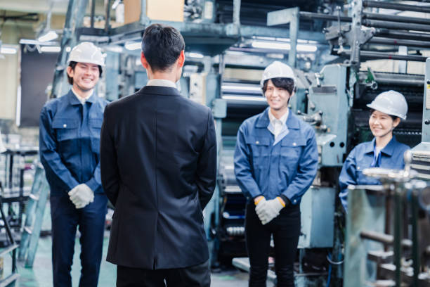 istock Factory staff listening to a manager's instruction 1476683394