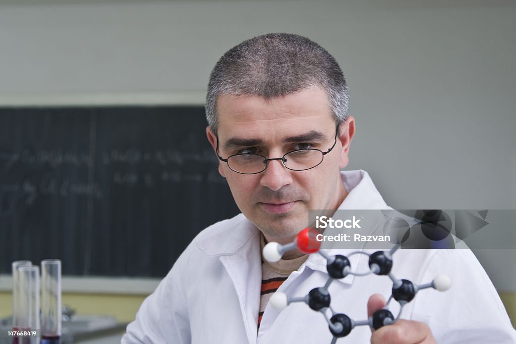 Researcher Male researcher looking at a model of a molecule. 30-39 Years Stock Photo