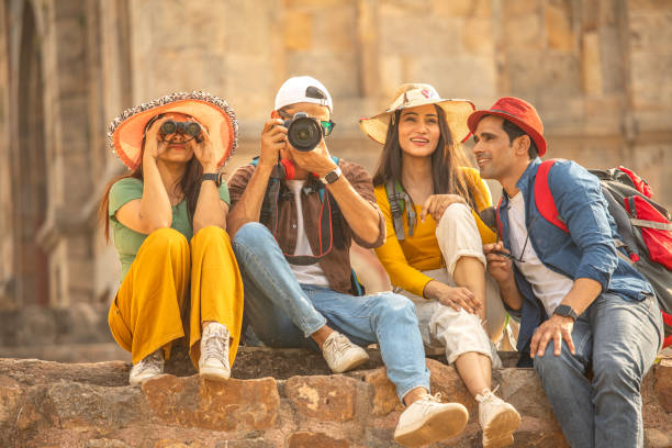 istock Friends admiring view using binoculars and camera at historic site 1476692267