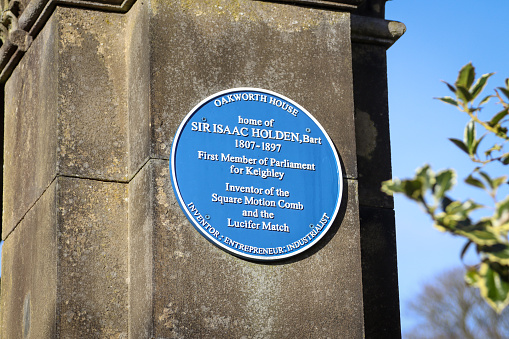 Memorial to Sir Isaac Holden, first Member of Parliament for Keighley in Oakworth Park, Yorkshire. Complete with blue plaque this greets visitors at the entrance to the park along with a war memorial and statues.