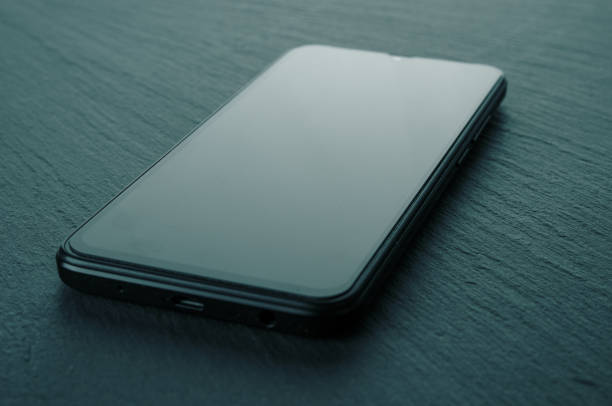 Smartphone with blank screen close up on a stone background