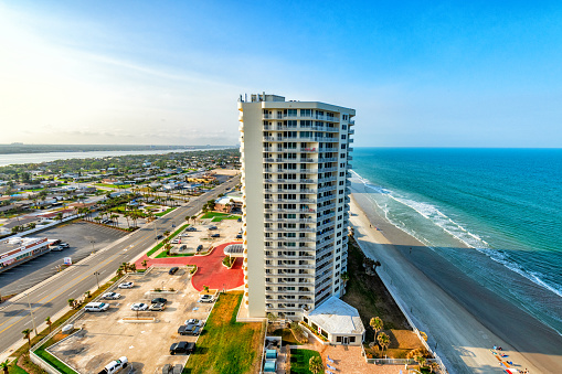 Daytona Beach, United States - March 5, 2023:  An ocean front,  high rise condominium residential tower on the beach in Daytona Beach, Florida.