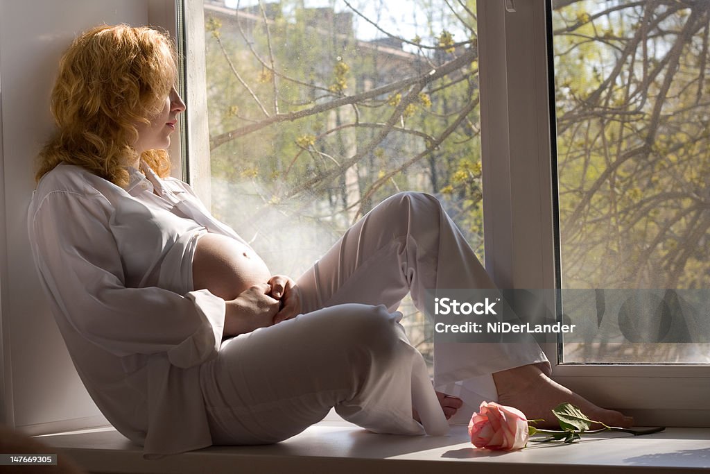 The mother to be Pregnant woman relaxing in the rays of sun Abdomen Stock Photo