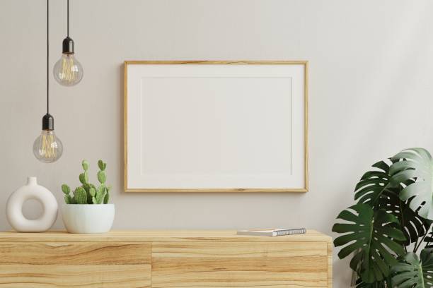 istock Horizontal picture frame mockup on empty wooden cabinet. 1476693750