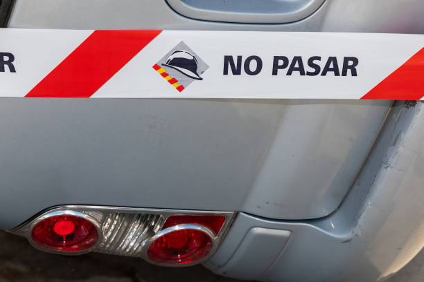 istock Sideways Car Crash: Spanish Firefighters Set Up No Passing Tape on Road 1476694062