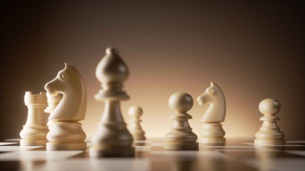 istock 3d rendering, chess game white pieces stand on the chessboard illuminated with warm light. Pawn, bishop, knight, horse 1476694442