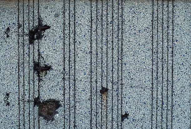 Distressed pebble wall with nails stock photo