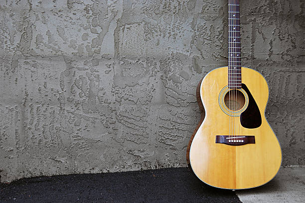 Acoustic Guitar by Block Wall stock photo