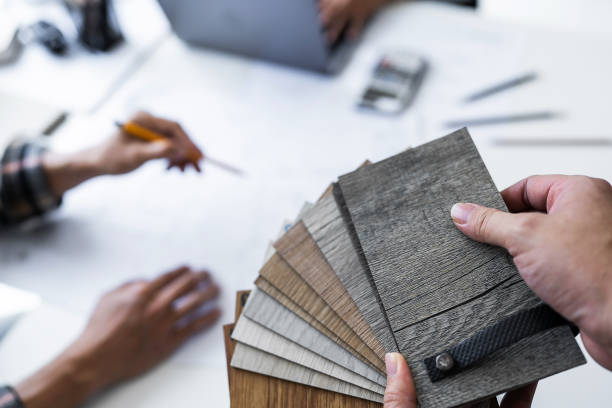 istock Close up of engineer hands holding wooden floor samples and meeting for architectural project. working with partner and engineering tools on workplace 1476697374